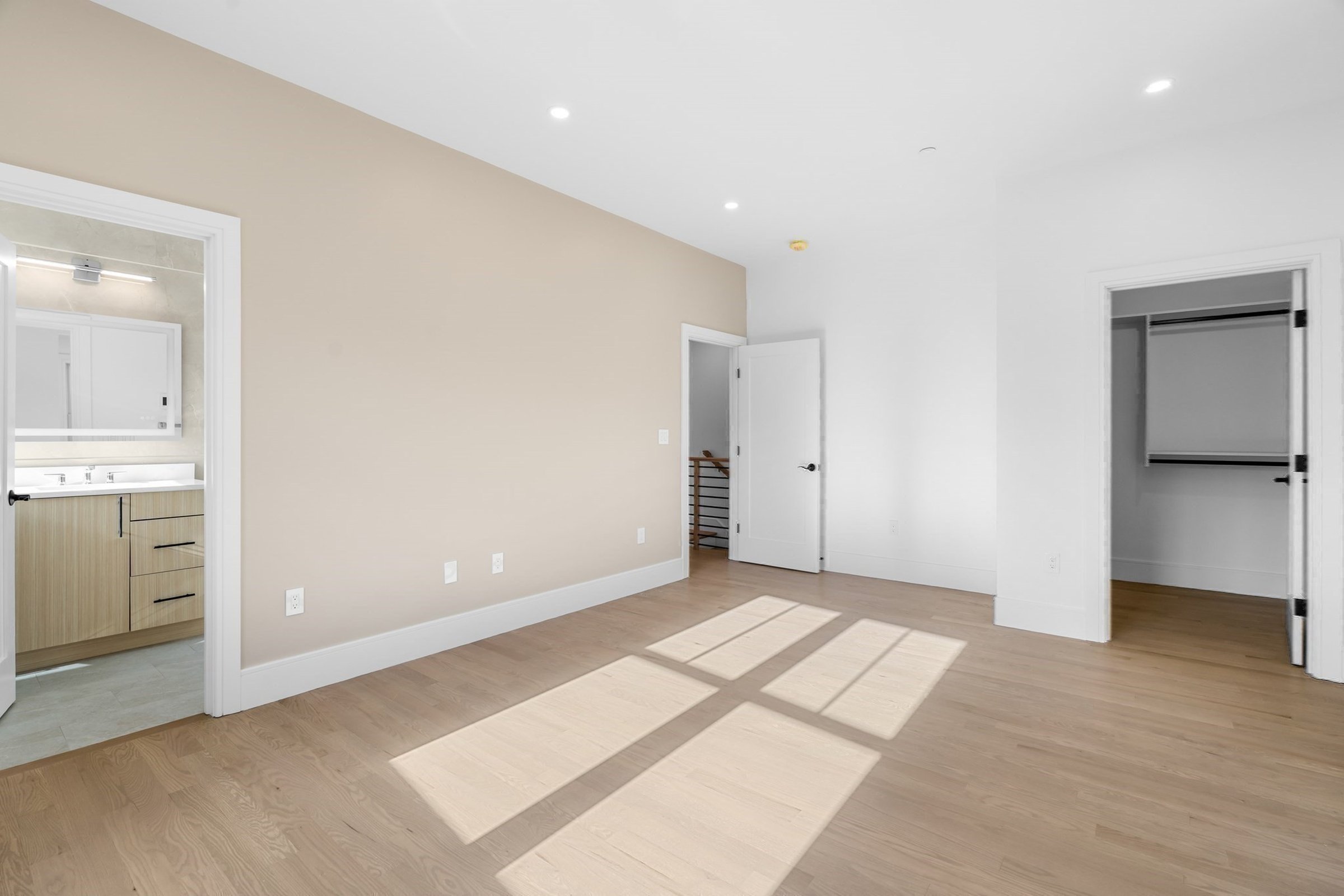 Sunlit bedroom with a walk-in closet and en-suite bath.
