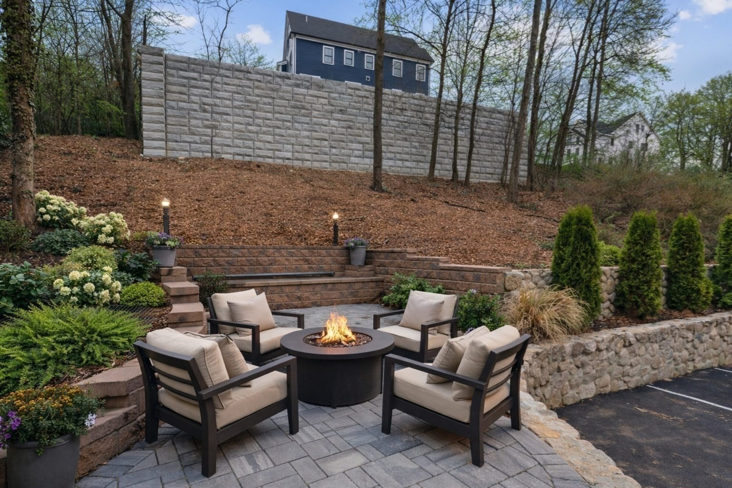 Rear patio with a fire pit and lounge seating at dusk.
