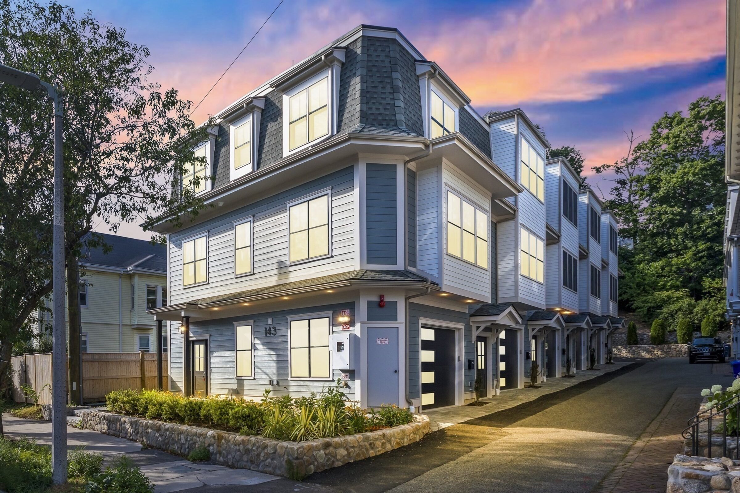 Twilight exterior of the townhome building.