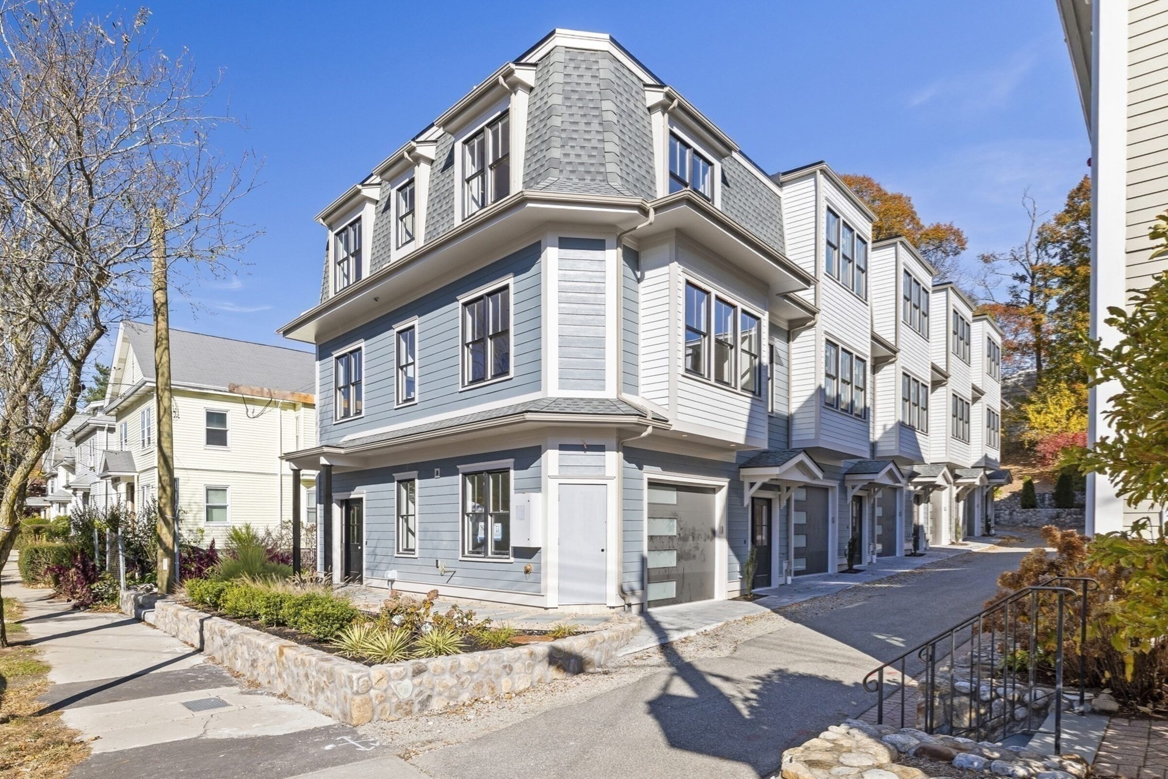Daytime exterior corner view of the townhome building.