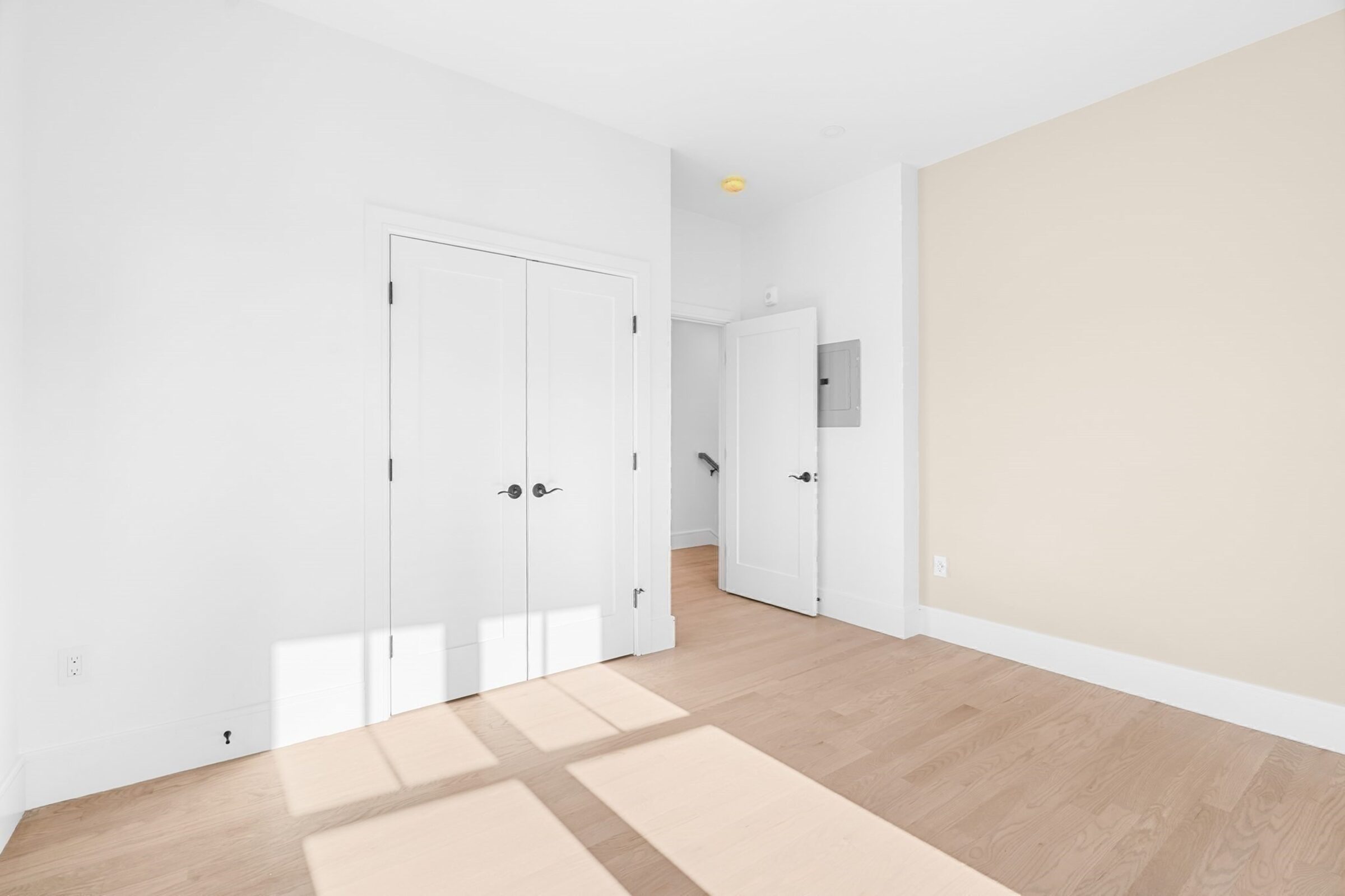 Sunlit bedroom with a double closet.