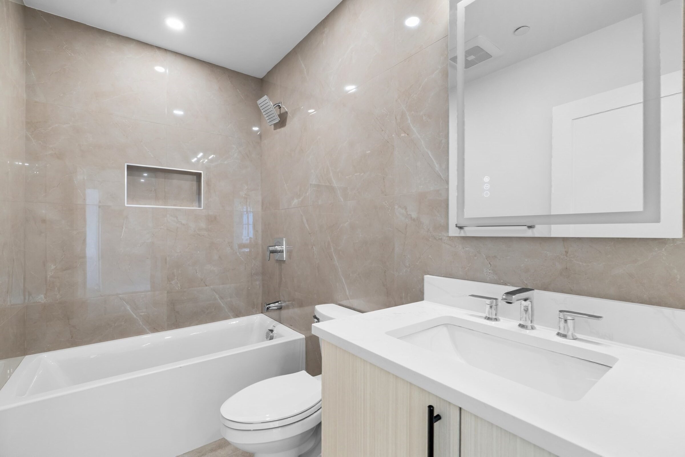Bathroom with a soaking tub and marble surround.
