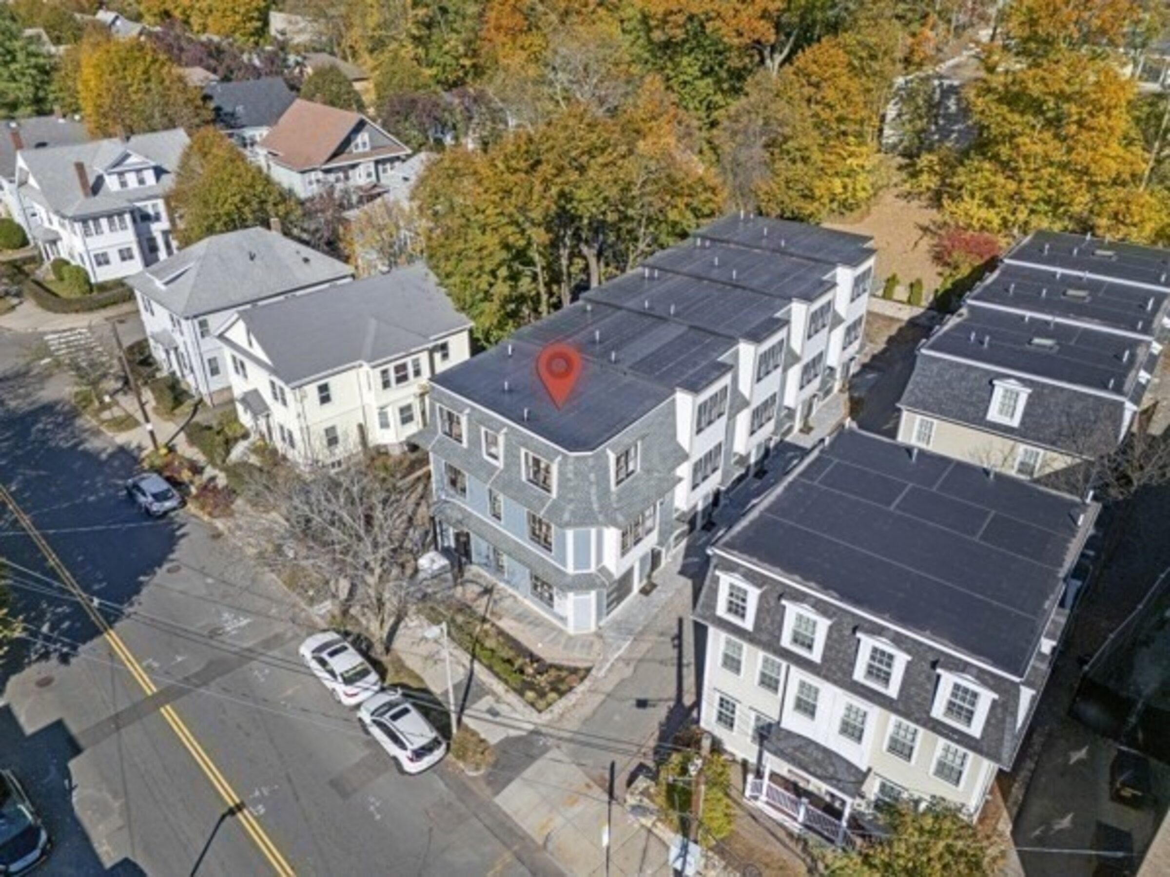 Aerial view of the townhome building and surrounding street.